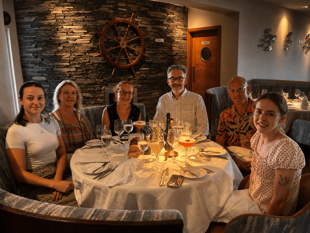 Claire Baley with family and friends gathered around the table at Jacks Restaurant in Cromane, County Kerry.