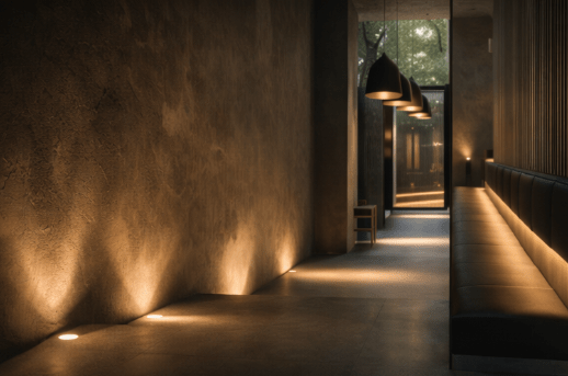 Architectural visualisation by Heron & Moss of a contemporary hallway with textured walls, concealed uplighting and warm ambient light.