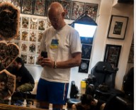 Kieran standing inside Ancient Rituals tattoo studio in Killarney before having his first tattoo.