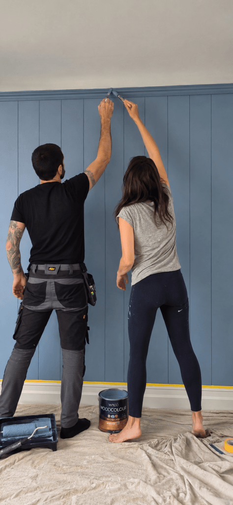 Helen and Gary working together on painted wall panelling during the renovation of Hatfield House.